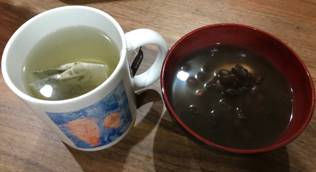 A cup of mugicha (tea with roasted brown rice) and red sweet bean (anko).